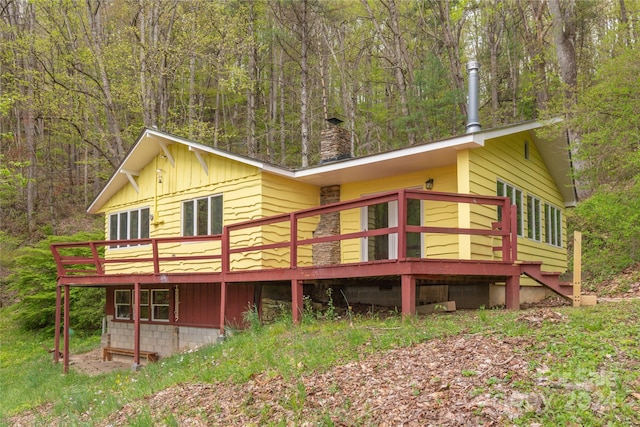 back of house with a wooden deck