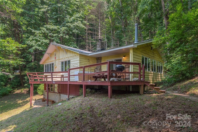 back of house featuring a deck