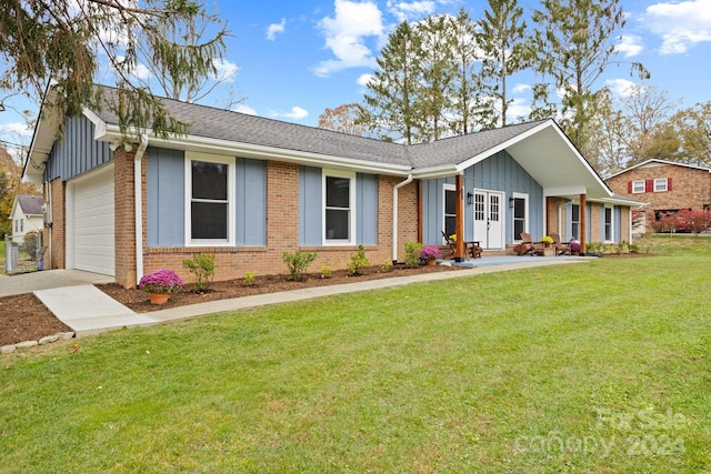 single story home featuring a garage and a front lawn