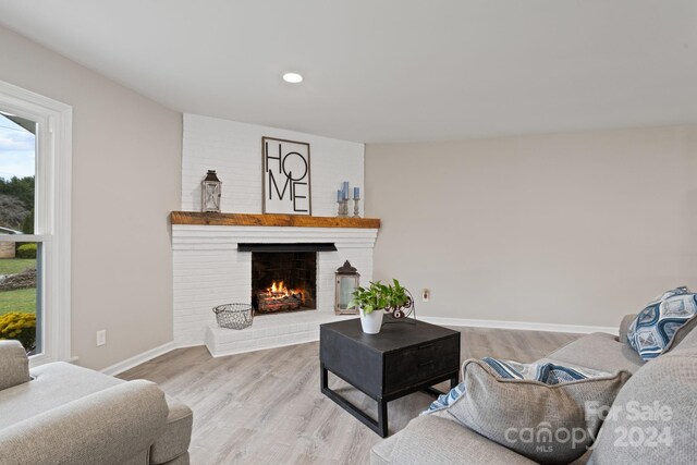 living room with light hardwood / wood-style flooring and a fireplace