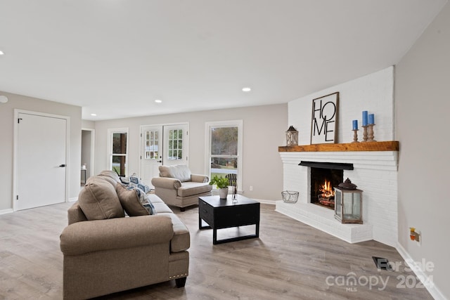 living room featuring a fireplace and light wood-type flooring