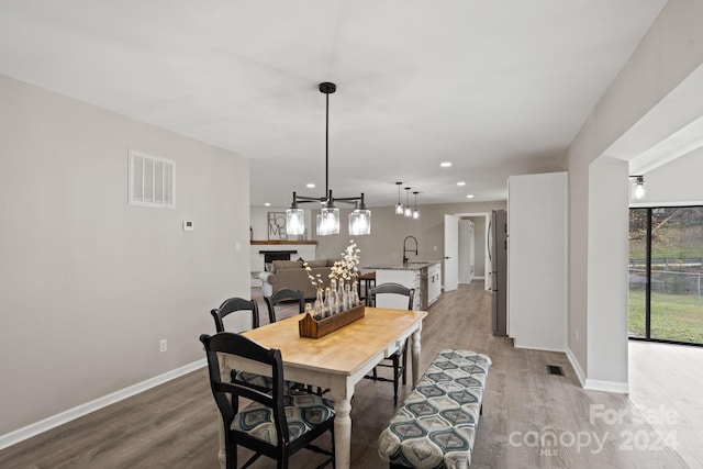 dining room featuring sink and light hardwood / wood-style flooring