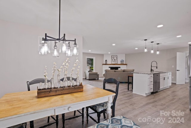 dining area featuring sink and light wood-type flooring