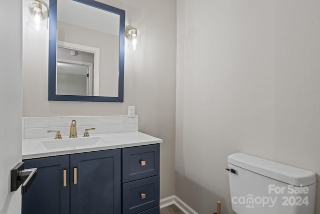 bathroom with toilet and vanity