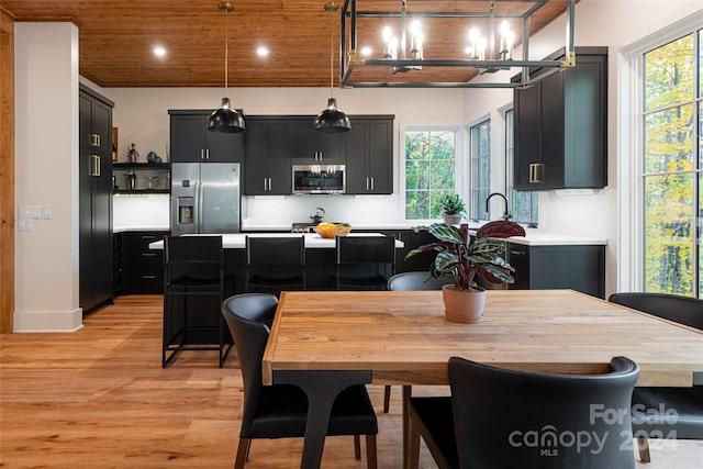 dining space with wooden ceiling, light hardwood / wood-style flooring, and a wealth of natural light