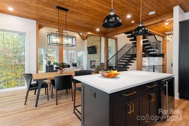 kitchen featuring wine cooler, wooden ceiling, plenty of natural light, and light wood-type flooring