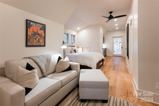 bedroom with vaulted ceiling, light hardwood / wood-style flooring, and ceiling fan