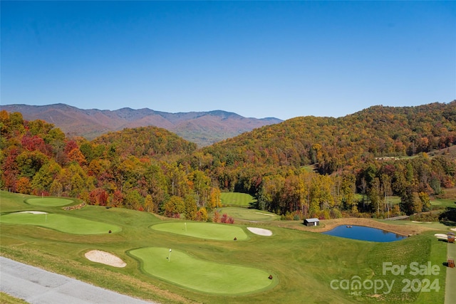 surrounding community with a water and mountain view