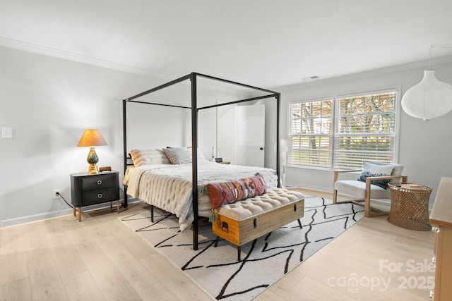 bedroom featuring light hardwood / wood-style flooring and crown molding