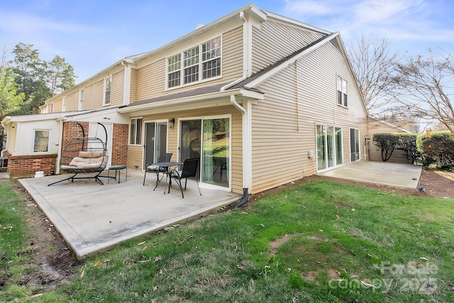 back of house featuring a patio area and a lawn