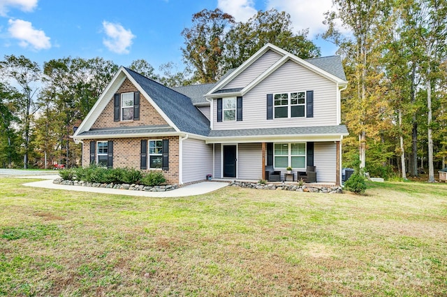 view of front of house featuring a porch and a front lawn