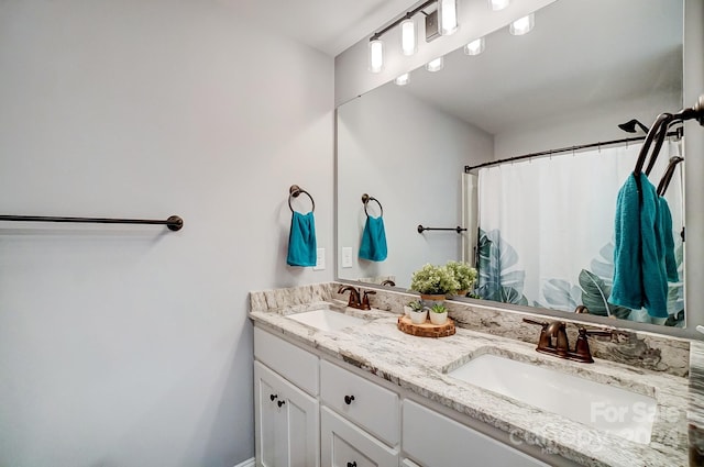 bathroom with a shower with shower curtain and vanity