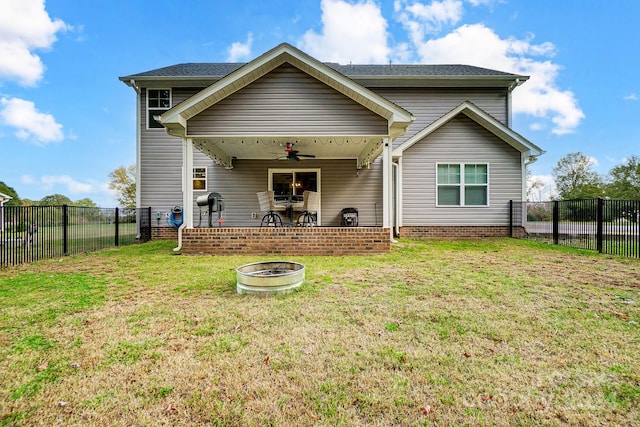 back of house with a patio area, a lawn, an outdoor fire pit, and ceiling fan