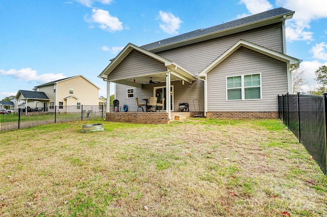 rear view of house with a patio, a yard, and ceiling fan