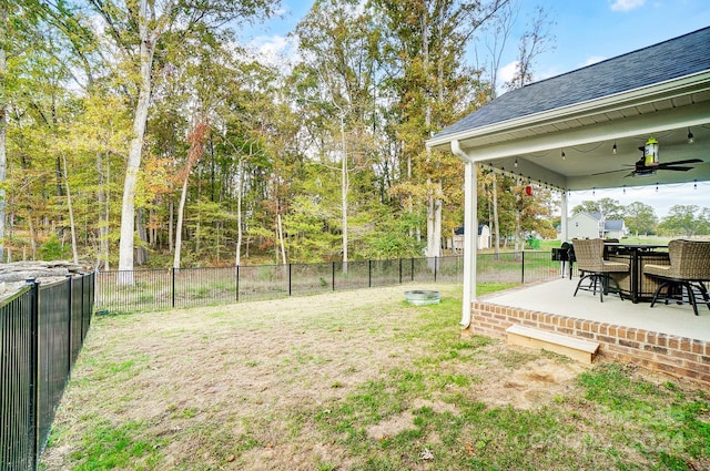 view of yard with a patio area and ceiling fan