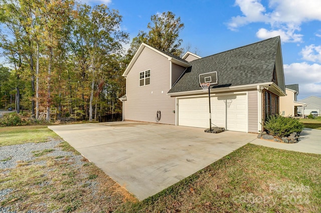 view of property exterior with a garage and a yard