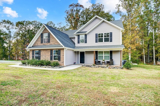 view of front of property with a porch, central AC, and a front yard