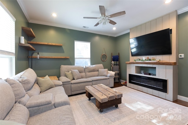 living room with ornamental molding, light hardwood / wood-style floors, and ceiling fan