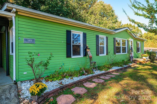 view of side of home featuring a lawn