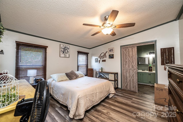 bedroom featuring a textured ceiling, ceiling fan, ensuite bathroom, and wood-type flooring