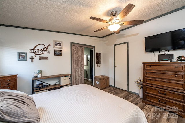 bedroom with dark wood-type flooring, ceiling fan, ornamental molding, and a textured ceiling