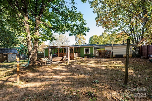 rear view of property with a shed