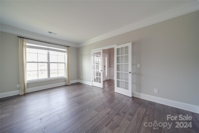 empty room featuring dark wood-type flooring, french doors, and ornamental molding