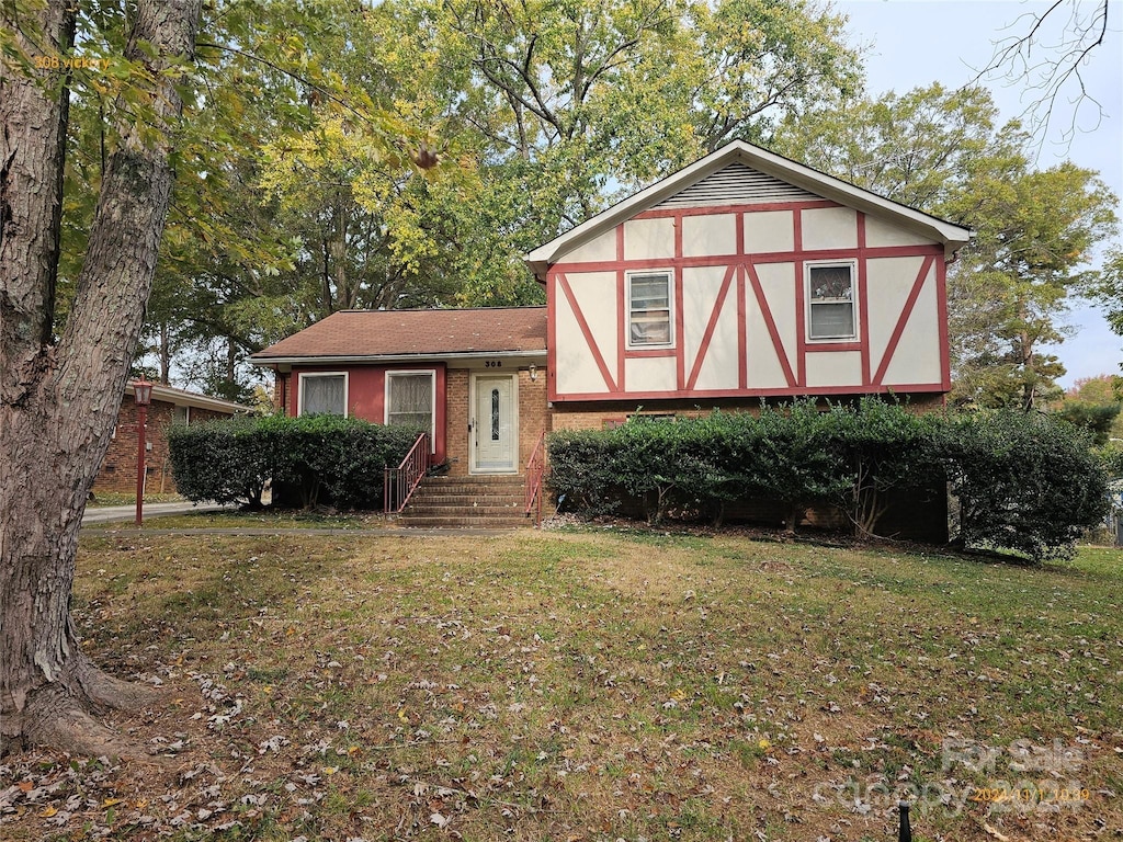 tudor home featuring a front yard