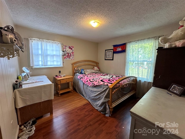 bedroom featuring dark wood-type flooring and a textured ceiling