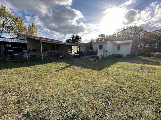 rear view of property with a yard