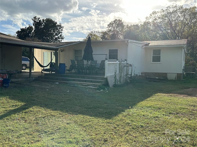 rear view of house with a yard