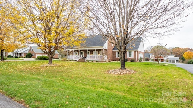 view of front facade with a front lawn and covered porch