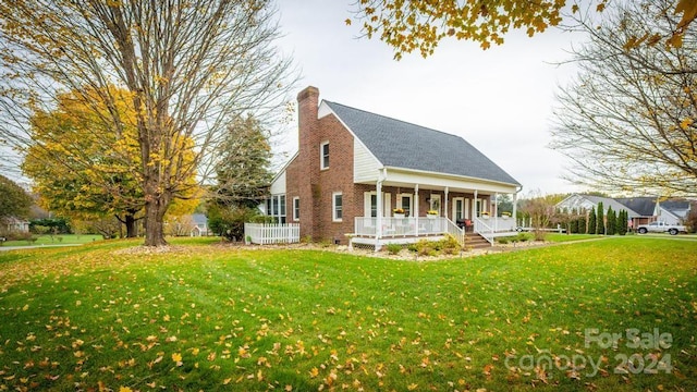 view of front of home with covered porch and a front lawn