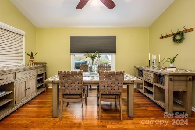 dining room with ceiling fan, dark wood-type flooring, and lofted ceiling