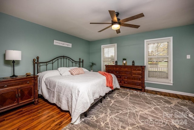 bedroom with ceiling fan and dark hardwood / wood-style flooring