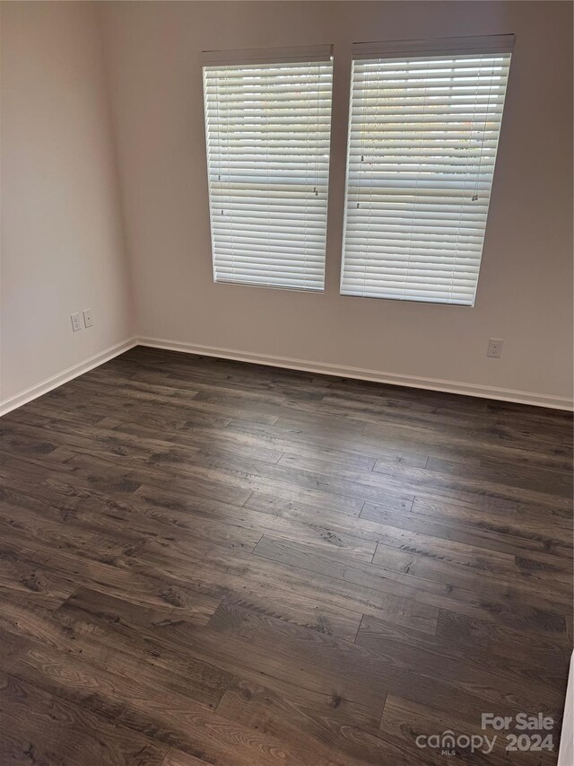 spare room with dark hardwood / wood-style flooring