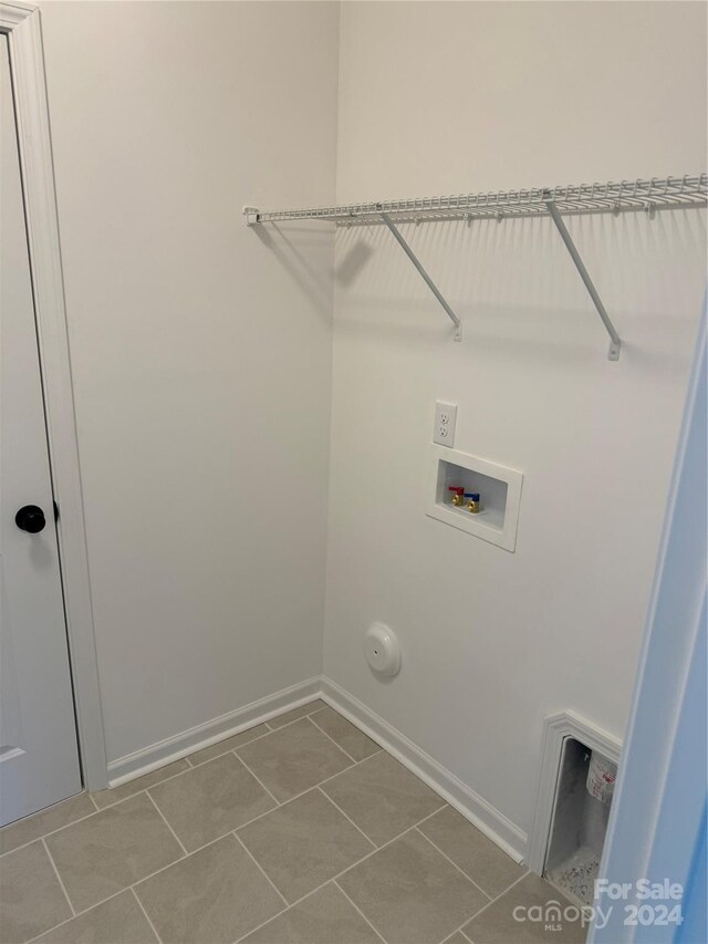 laundry area featuring washer hookup and tile patterned floors