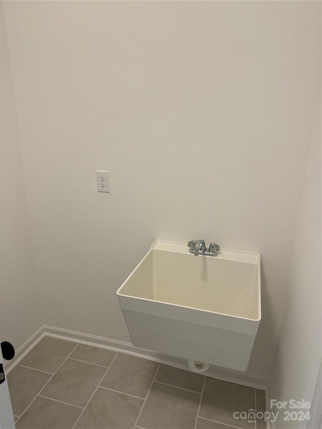 washroom with sink and tile patterned flooring