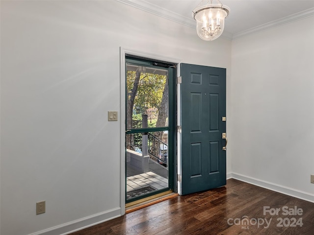 foyer featuring crown molding, a chandelier, and dark wood-type flooring