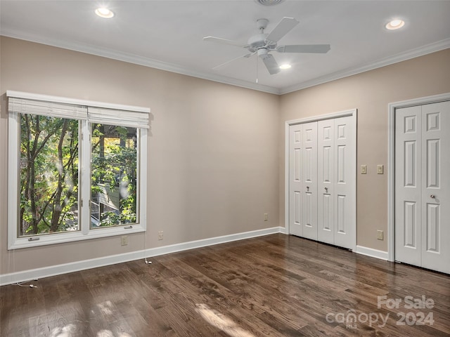 unfurnished bedroom featuring ornamental molding, ceiling fan, and dark hardwood / wood-style flooring