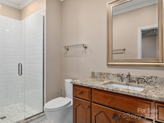 bathroom featuring vanity, toilet, crown molding, and an enclosed shower