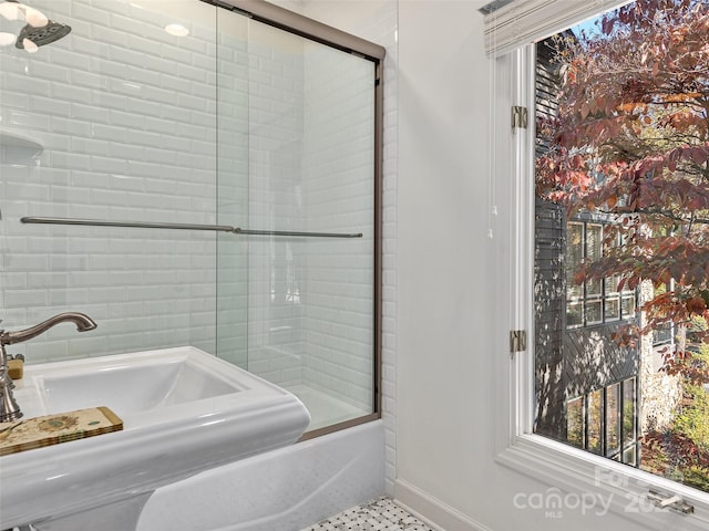 bathroom with shower / bath combination with glass door