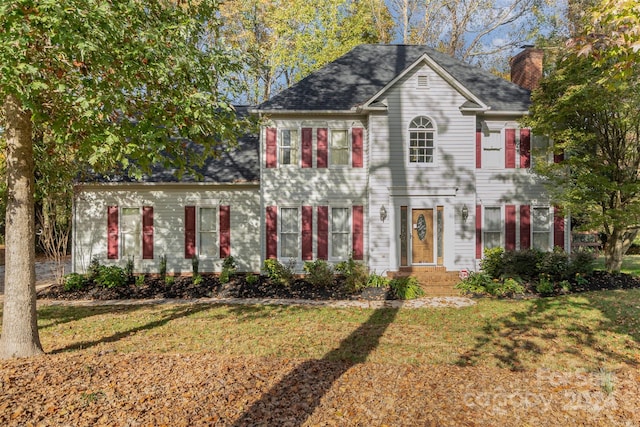 colonial home with a front lawn