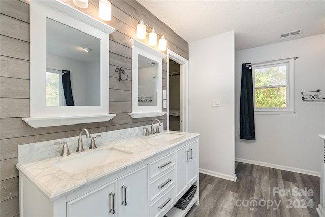 bathroom featuring vanity, hardwood / wood-style floors, and a textured ceiling