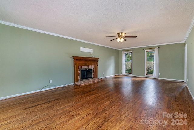 unfurnished living room with a textured ceiling, a brick fireplace, hardwood / wood-style floors, ceiling fan, and ornamental molding