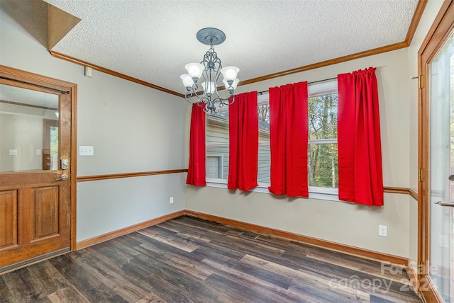 unfurnished dining area with ornamental molding, a notable chandelier, a textured ceiling, and dark hardwood / wood-style flooring