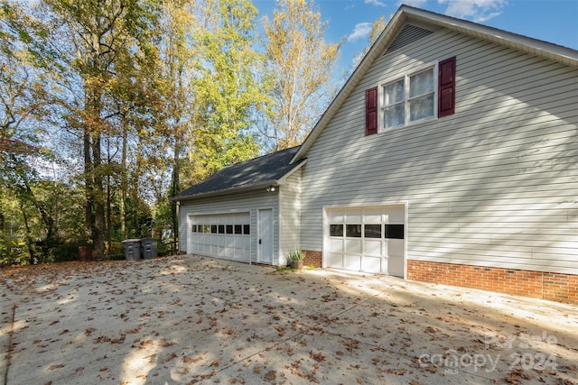 view of side of property featuring a garage