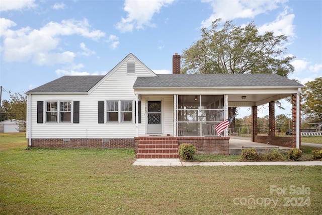 view of front facade with a carport and a front yard