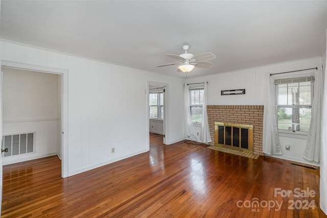 unfurnished living room with hardwood / wood-style floors, a fireplace, and ceiling fan