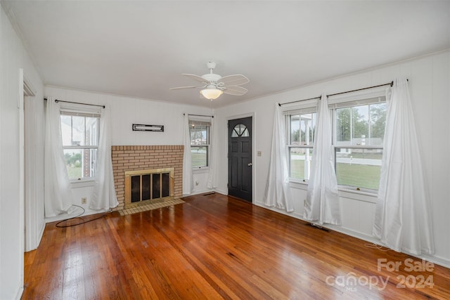 unfurnished living room featuring a wealth of natural light and wood-type flooring